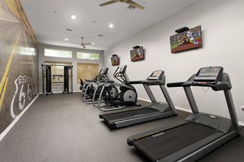 A gym with treadmills and exercise equipment.